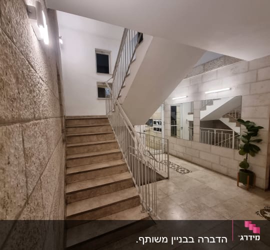 גרם מדרגות עם קירות אבן ותאורה חזקה